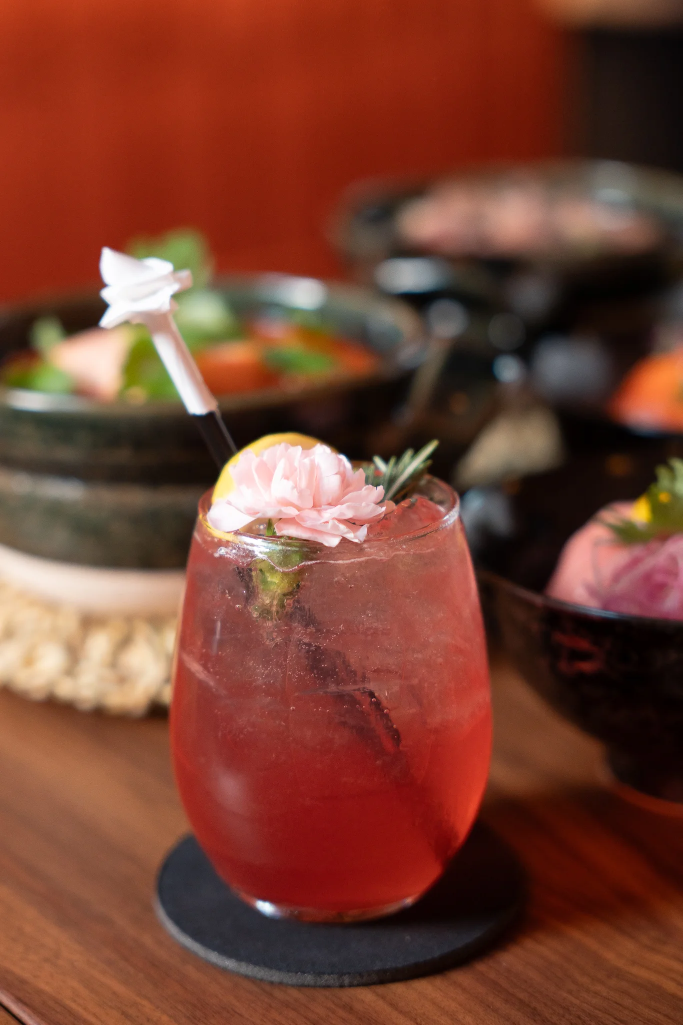 Refreshing floral cocktail with pink garnish