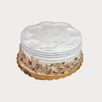 Delicious tres leches cake topped with whipped cream and strawberries.