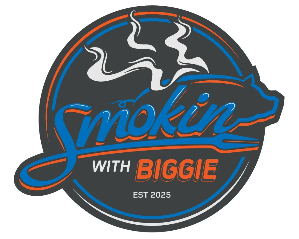 A food truck with branding that includes the name 'Smokin with Biggie' and a graphic featuring smoke. The truck is parked in a grassy area with a few trees in the background.