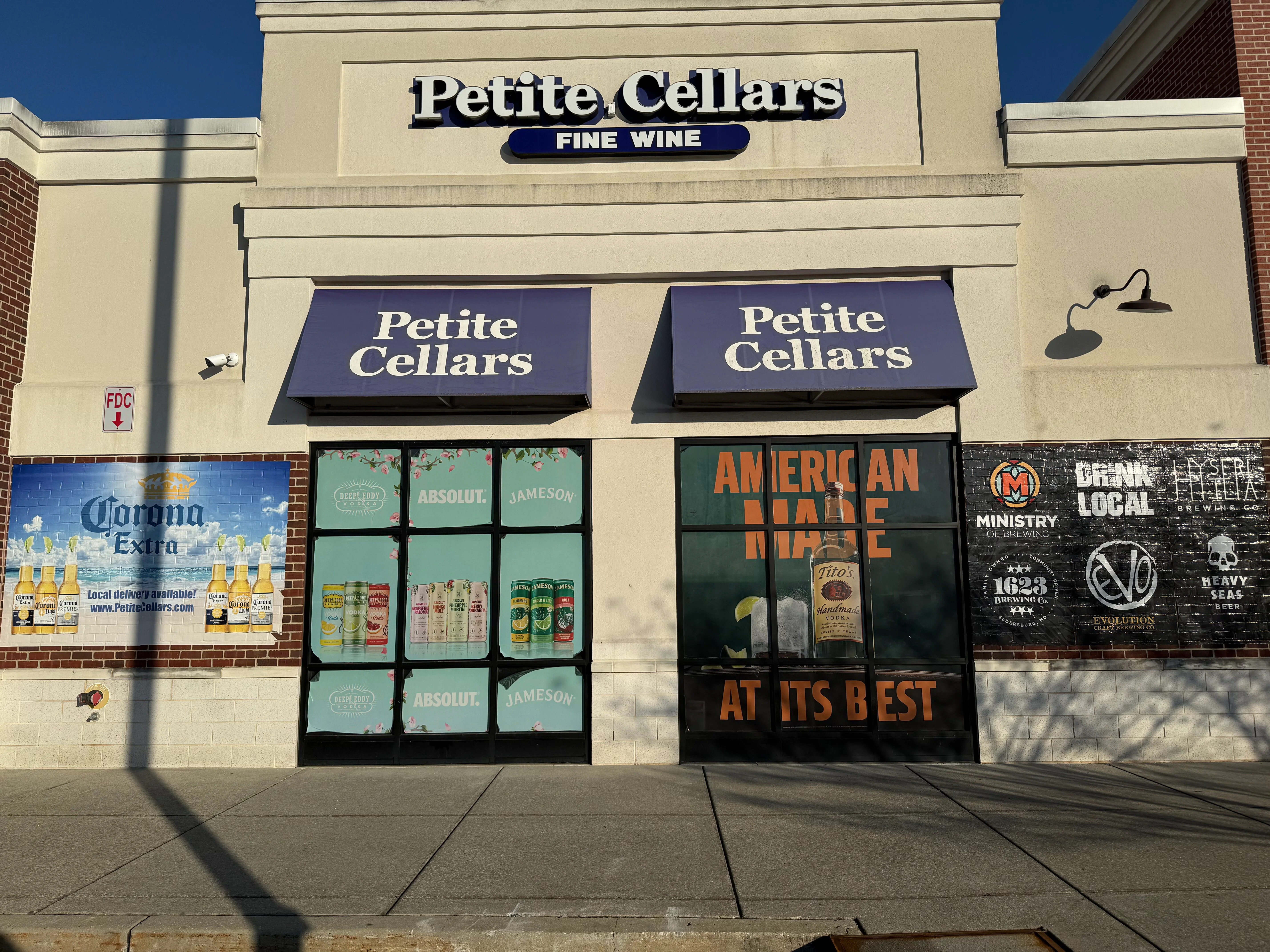 Exterior of Petite Cellars wine and spirits store with promotional signage