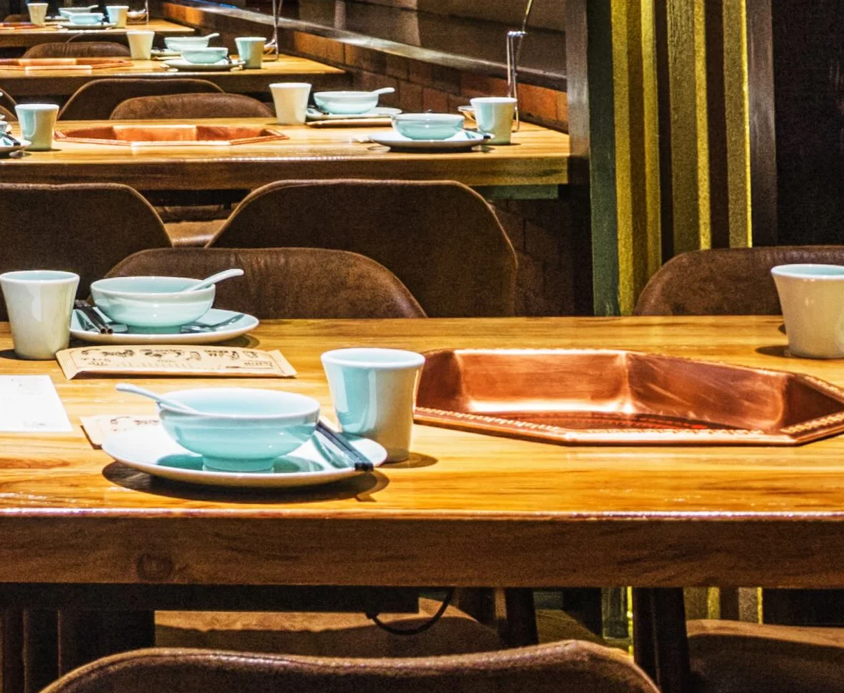 Cozy restaurant interior with wooden tables and warm lighting
