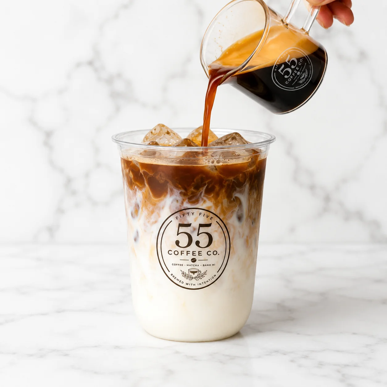Iced coffee with milk and espresso poured over ice