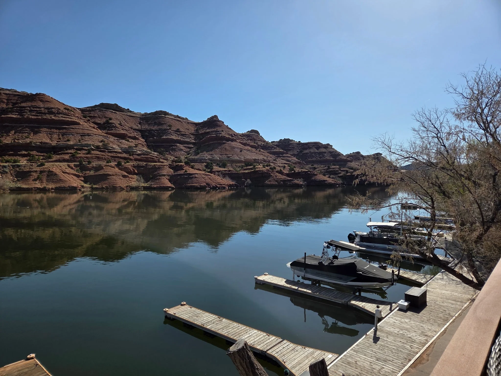 Scenic view of a calm lake surrounded by red rock formations