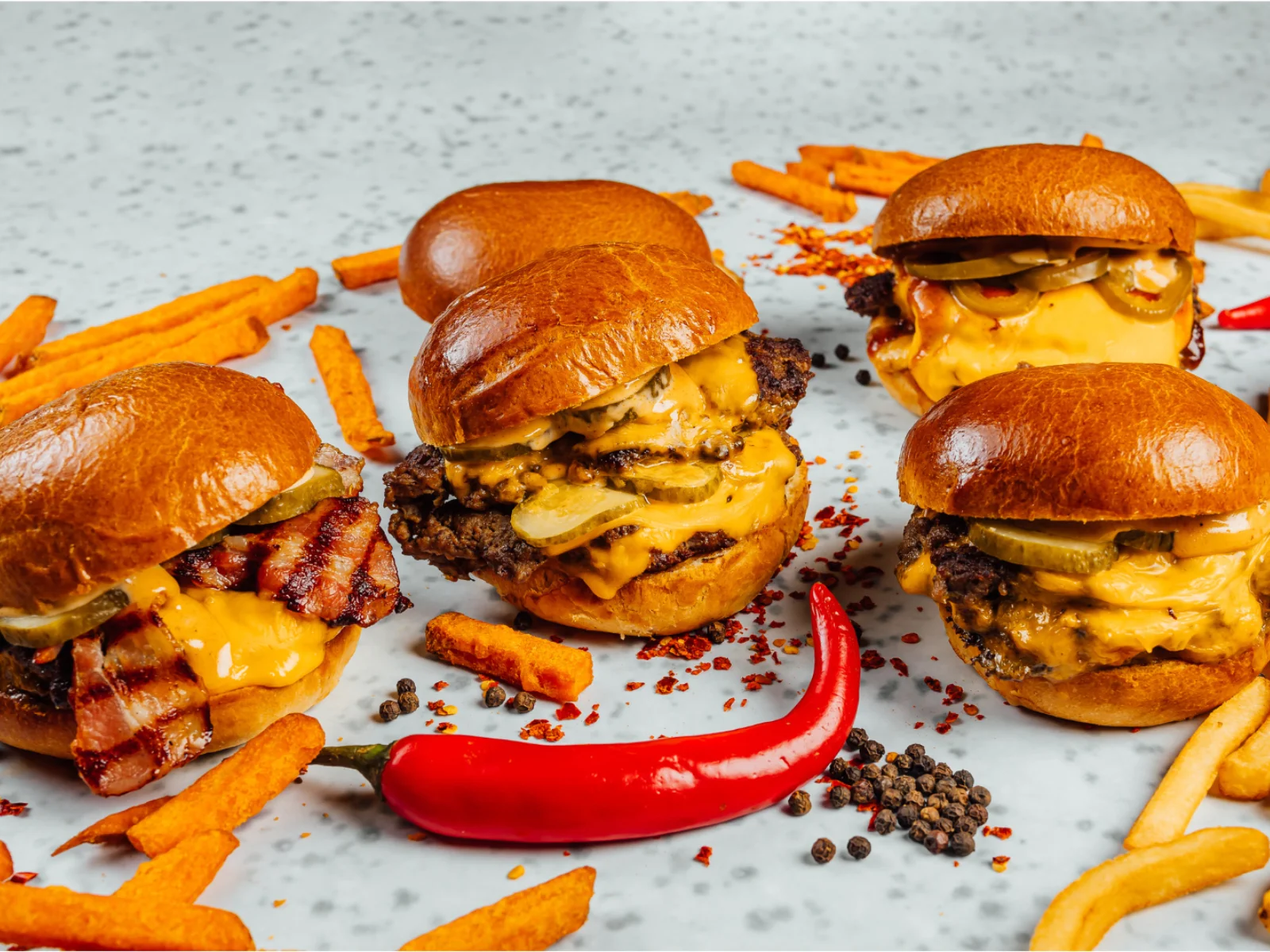 Gourmet cheeseburgers with bacon and pickles