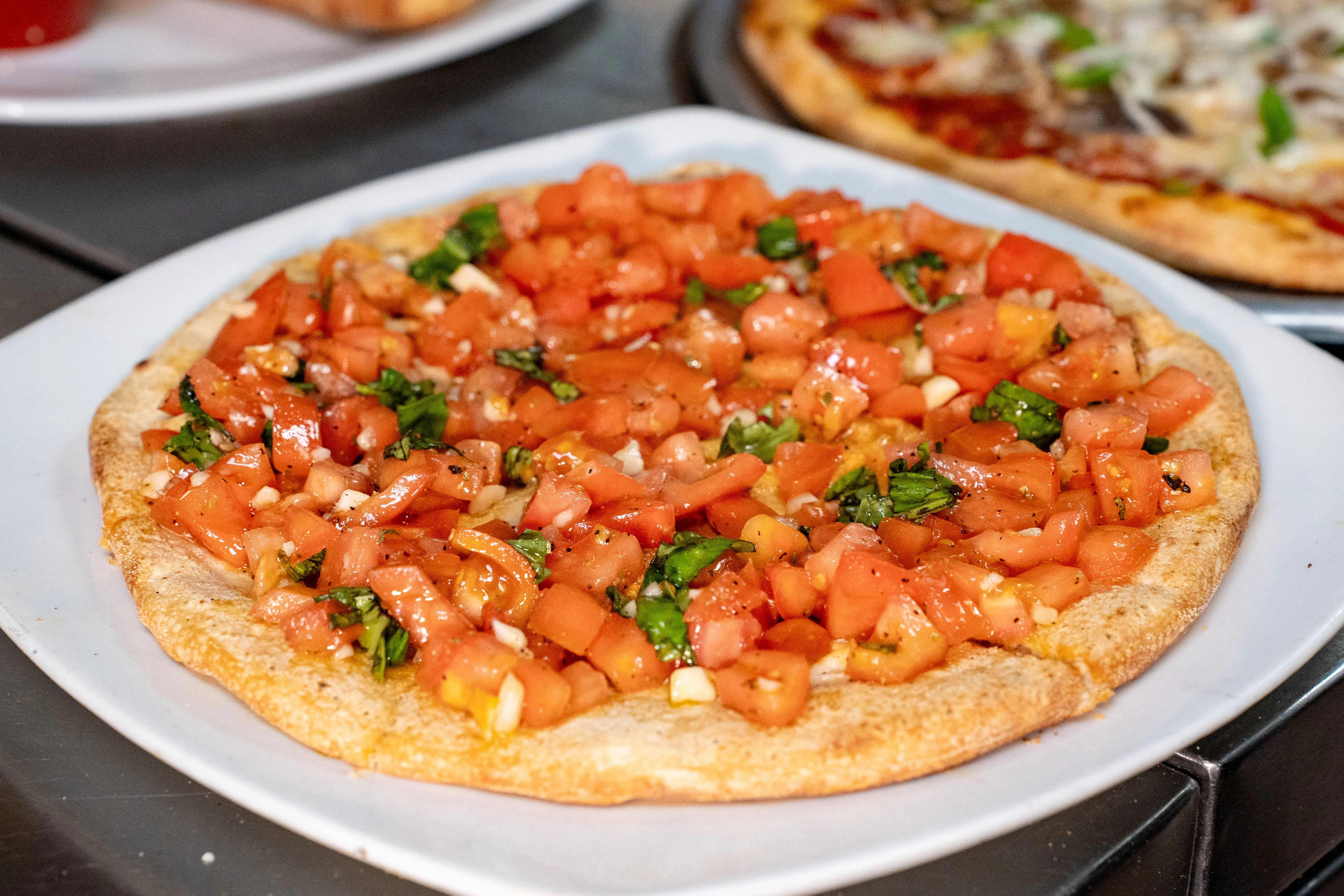 Bruschetta pizza topped with fresh tomatoes and basil