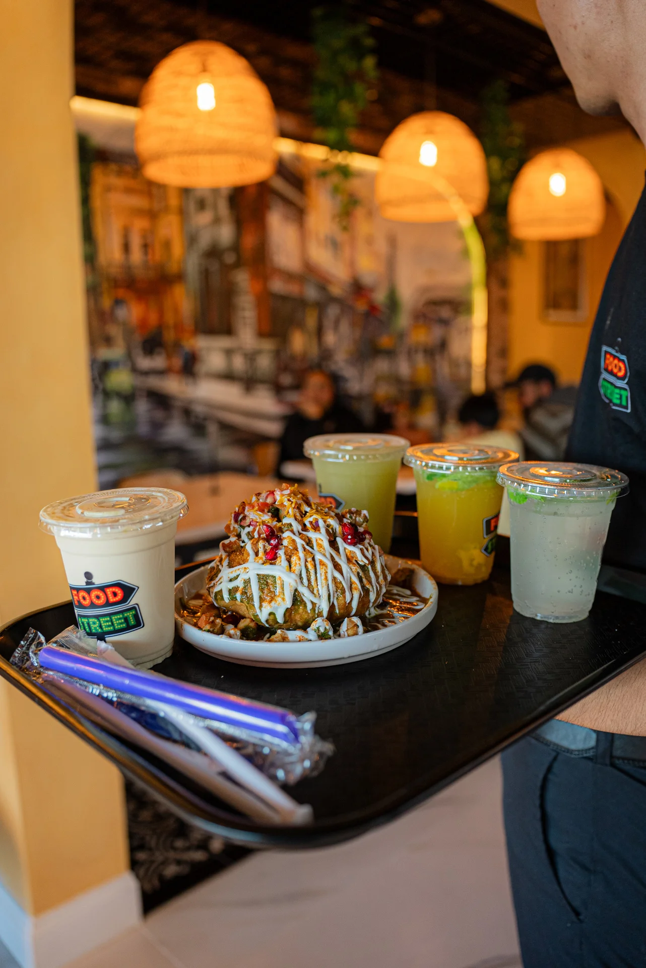 Indian chaat platter with colorful toppings and refreshing drinks