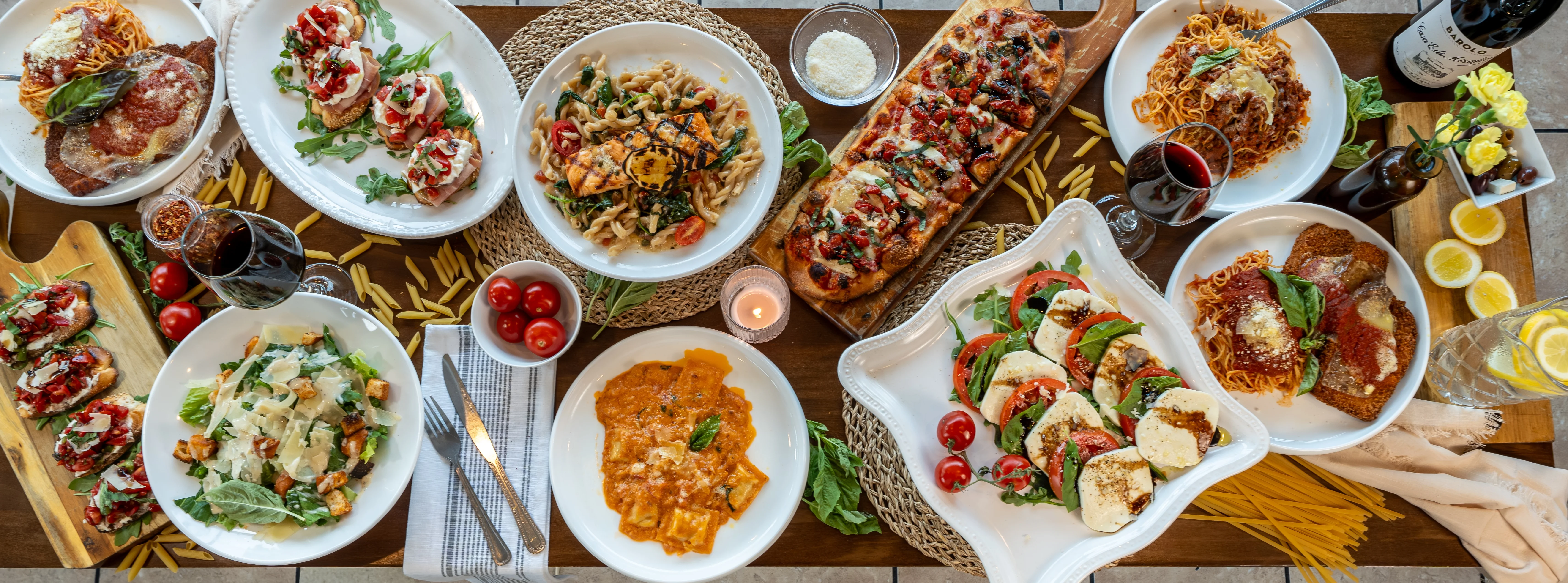 Italian feast featuring pasta, pizza, and fresh salads