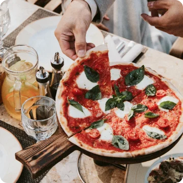 Margherita pizza served at a restaurant table