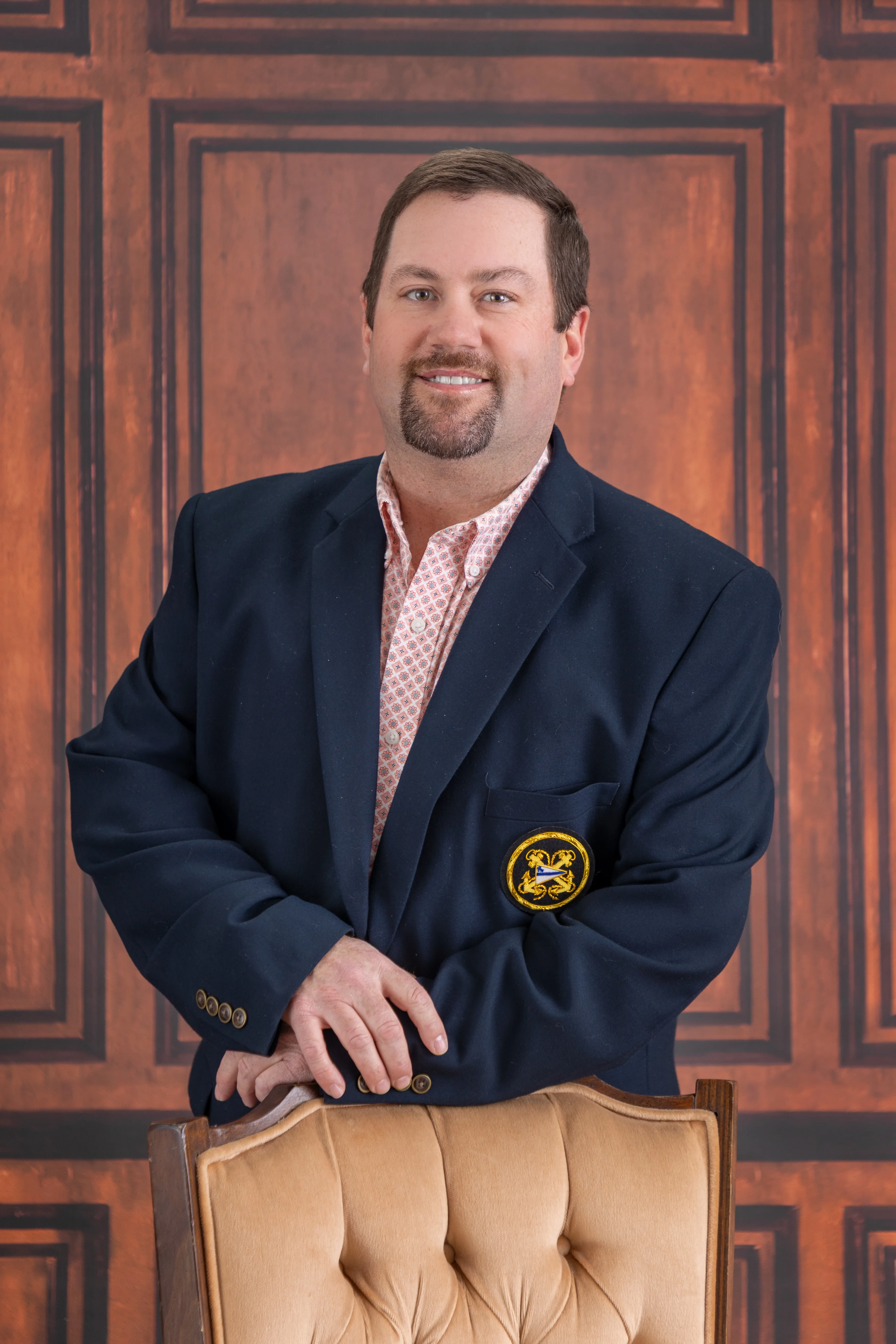 Professional portrait of a man in a blazer with a warm background