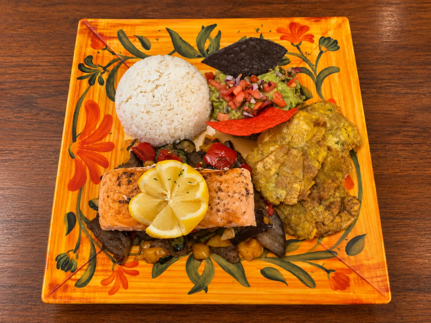 Grilled salmon plate with rice and plantains, showcasing Latin American cuisine