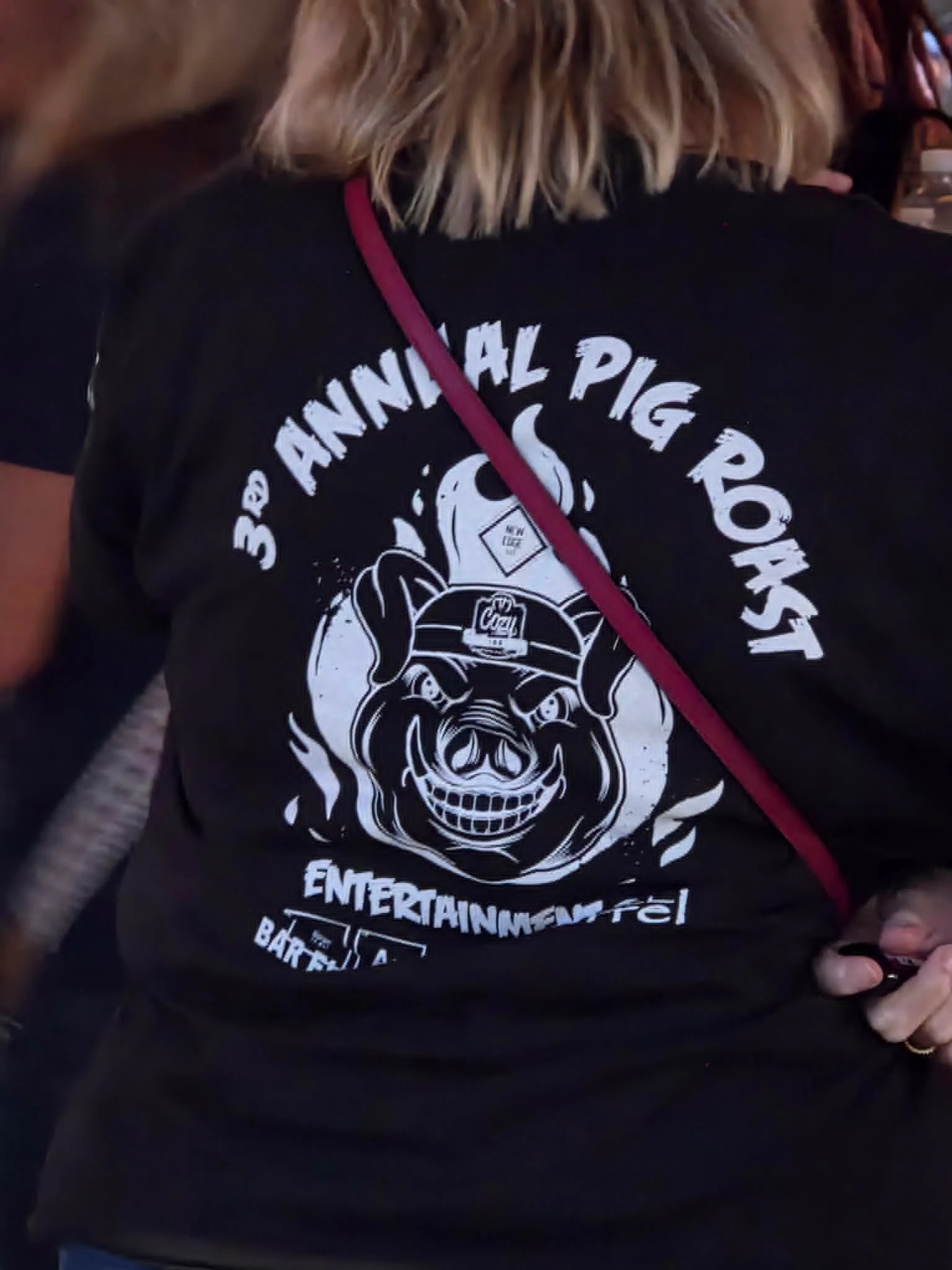 Person wearing a shirt for the 3rd Annual Pig Roast event