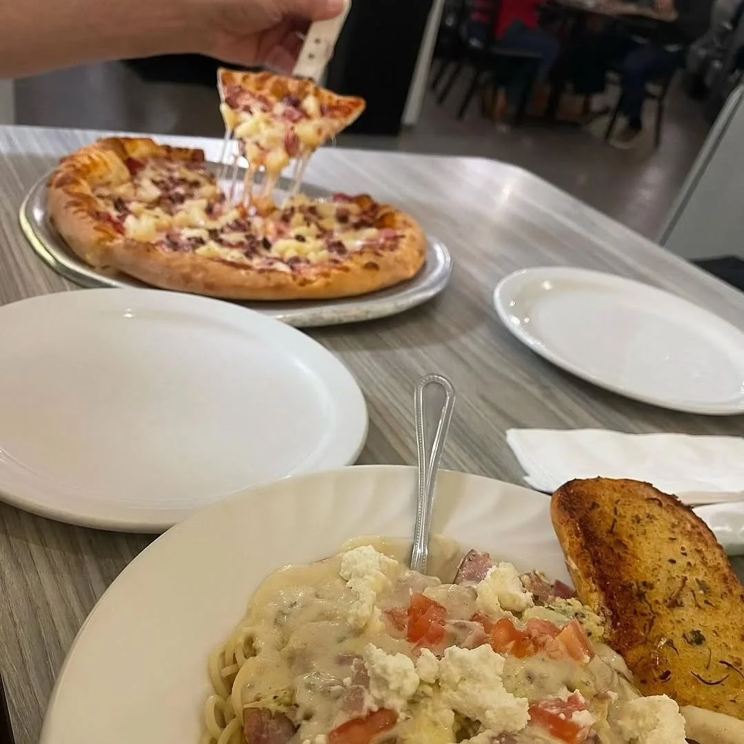 Creamy fettuccine Alfredo with garlic bread and cheesy pizza