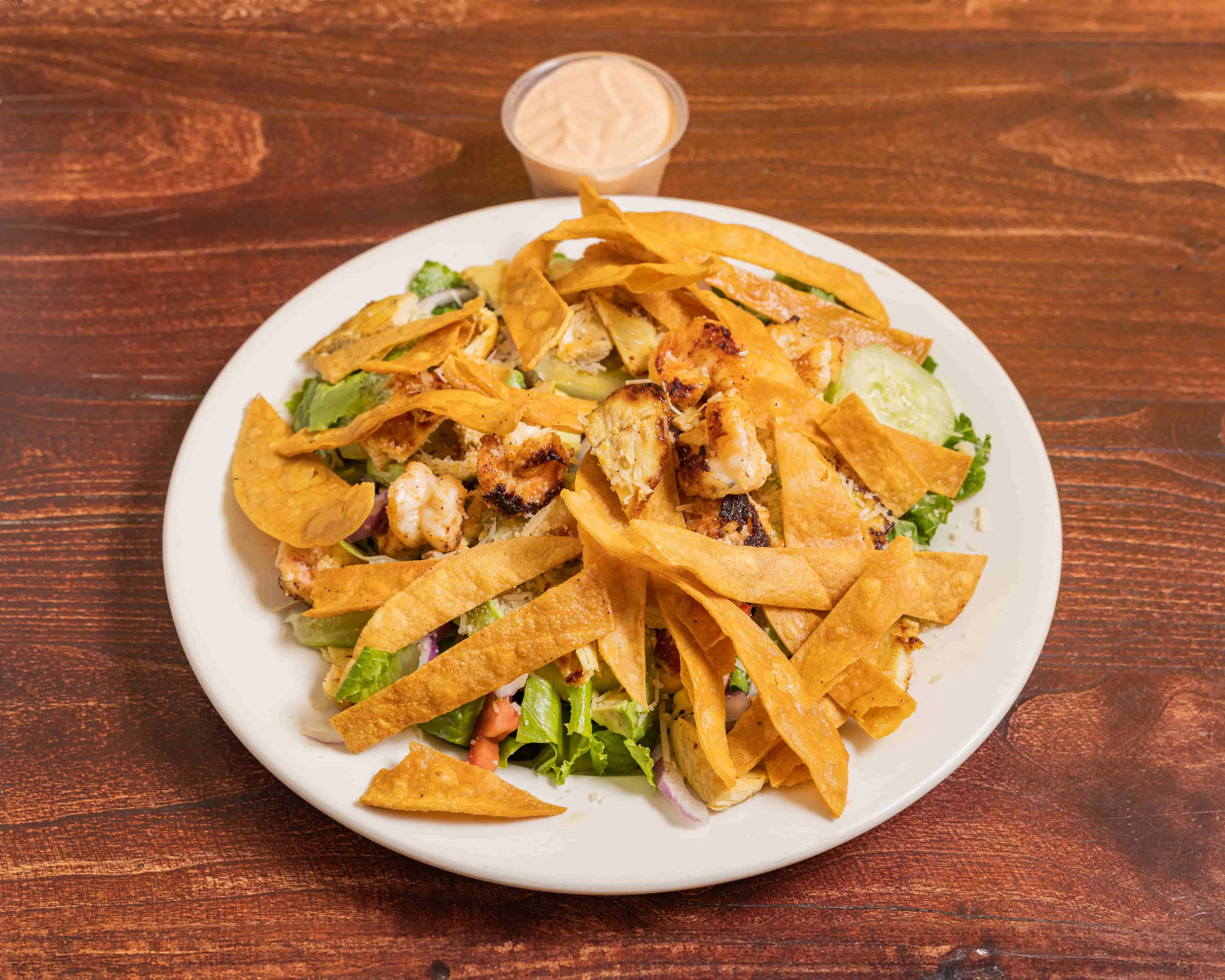 Grilled chicken salad with tortilla strips and creamy dressing