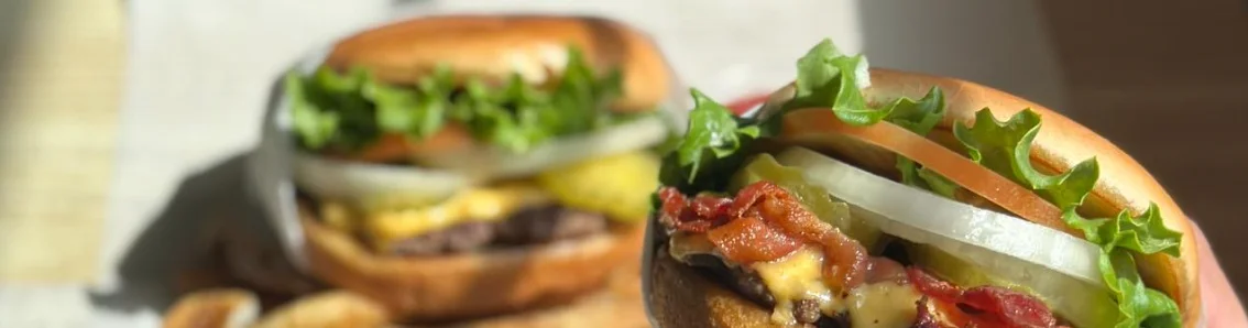 Juicy cheeseburger with bacon and fresh toppings