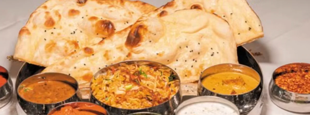 Indian thali with naan and assorted curries