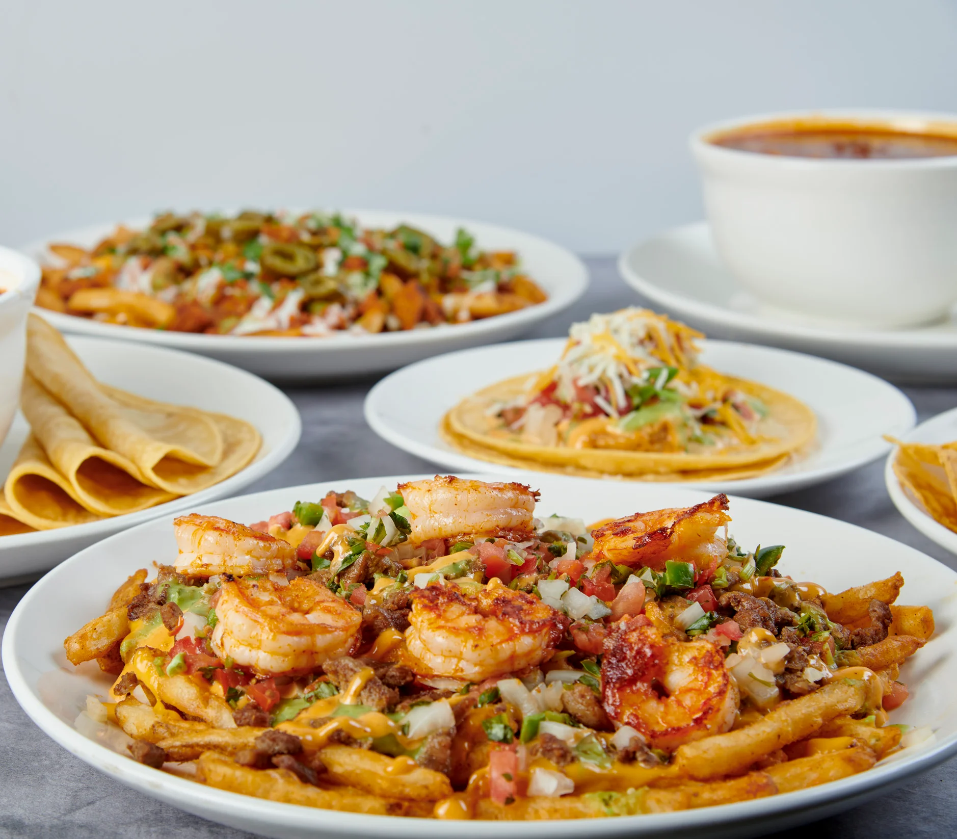 Shrimp-loaded Mexican nachos with cheese and toppings