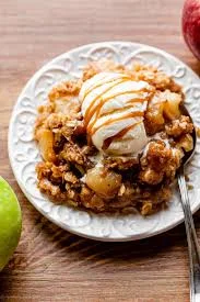 Warm apple crisp topped with vanilla ice cream