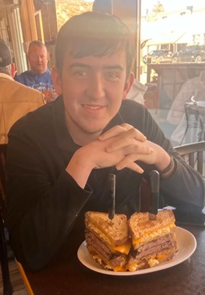 Stacked Reuben sandwich in a cozy restaurant setting