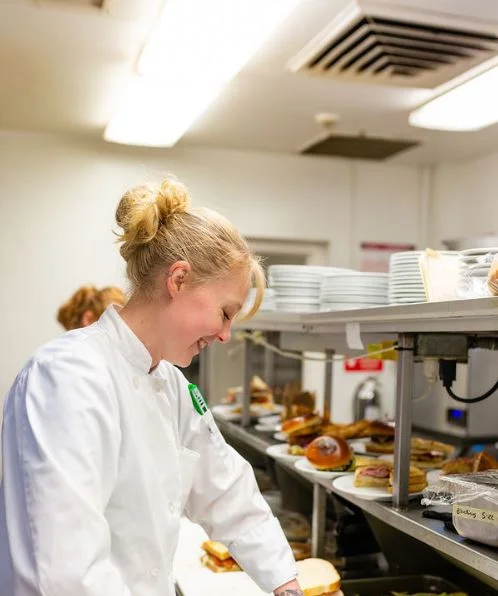 Chef preparing dishes in a busy restaurant kitchen