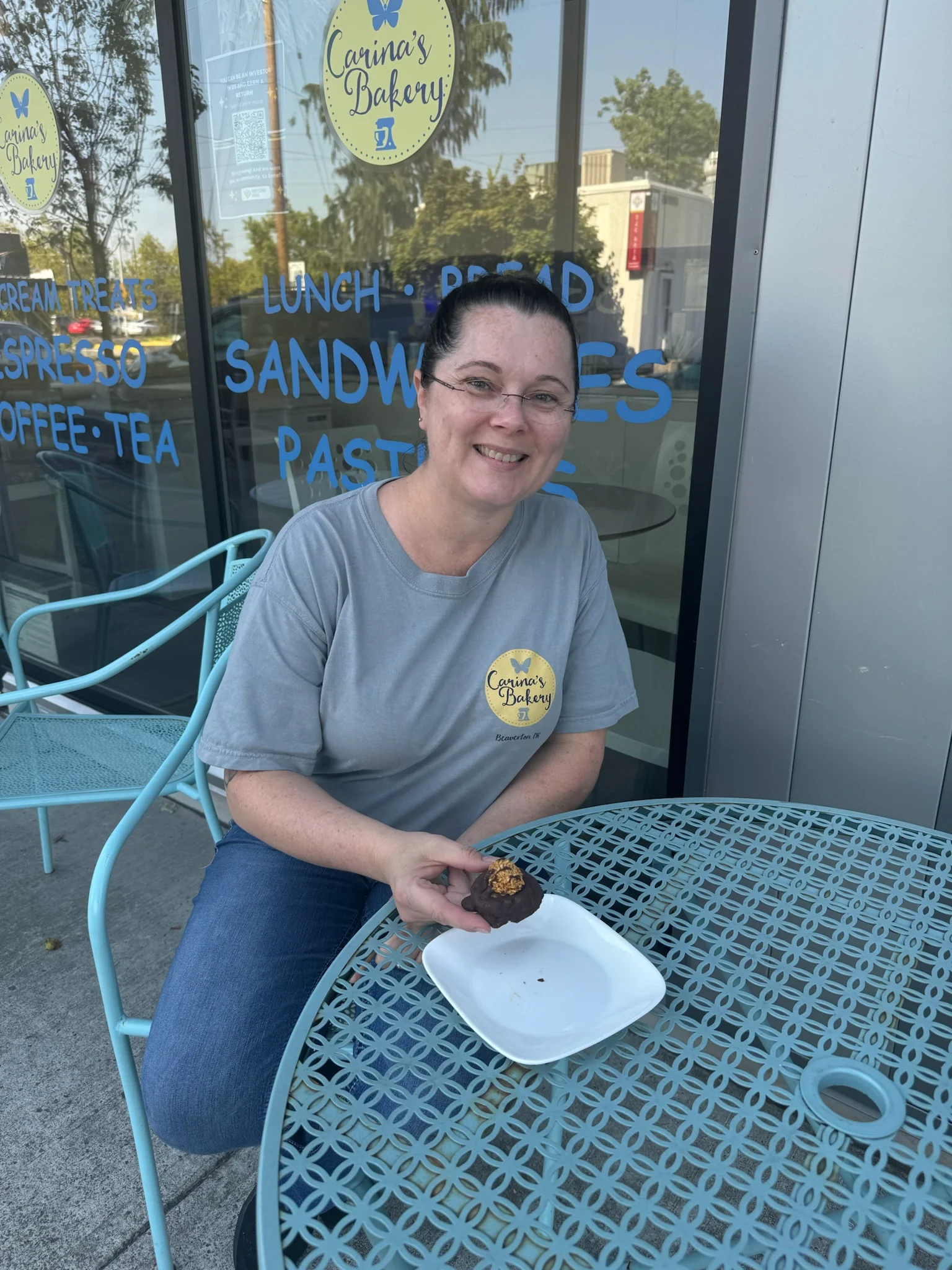 Customer enjoying a chocolate dessert at Carina's Bakery