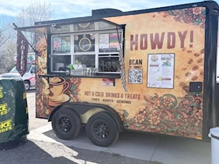 Colorful coffee trailer offering hot and cold drinks