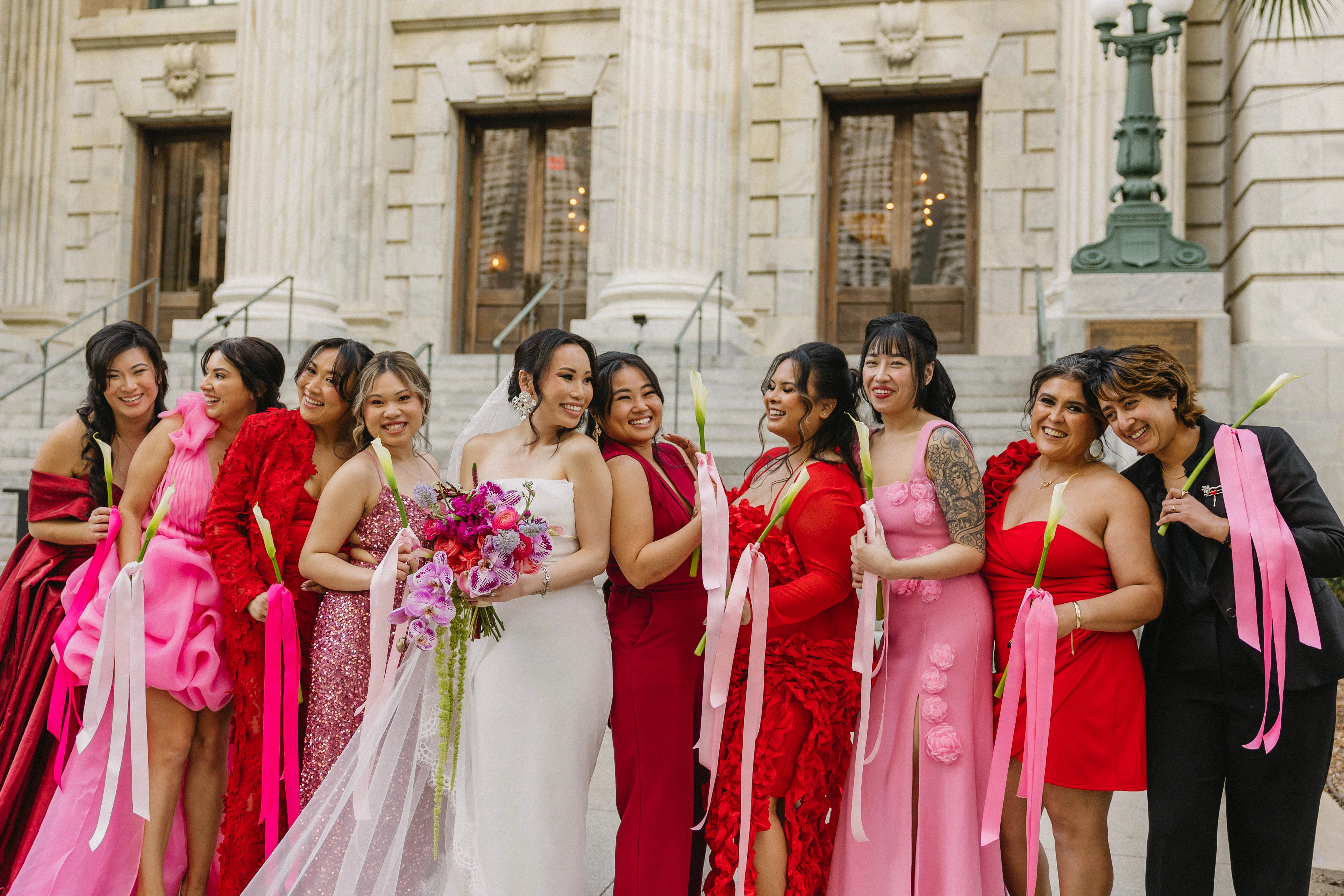 Bridal party in colorful dresses celebrating outdoors