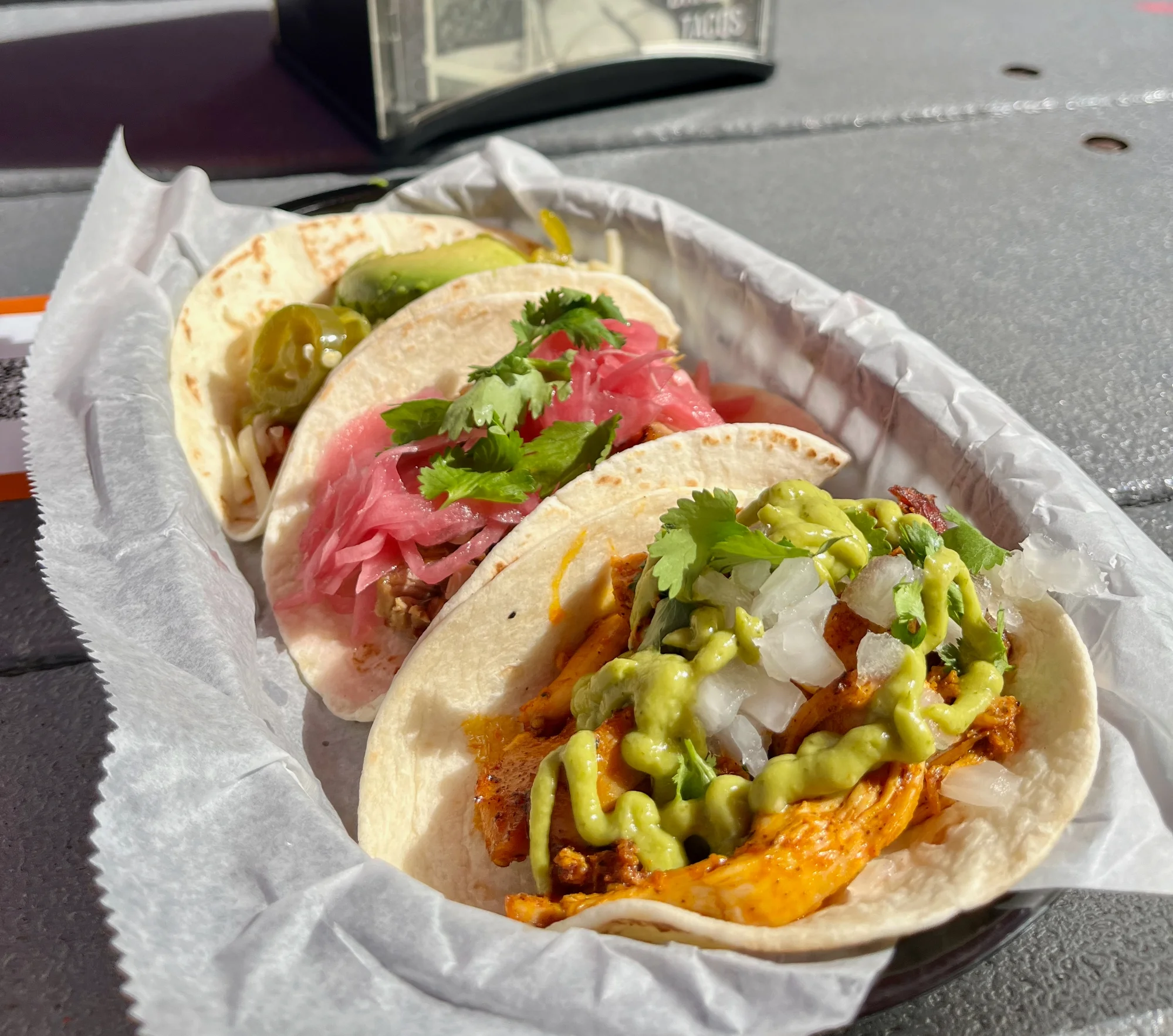 Three tacos on Brazos Tacos patio in the IX Art Park