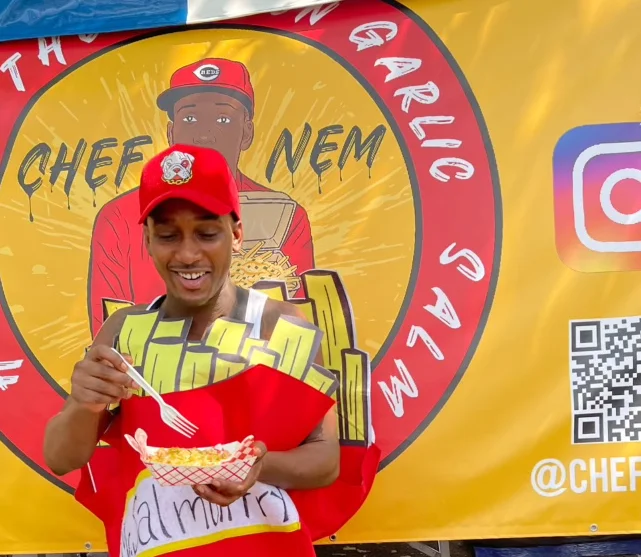 Person enjoying loaded fries at a food festival