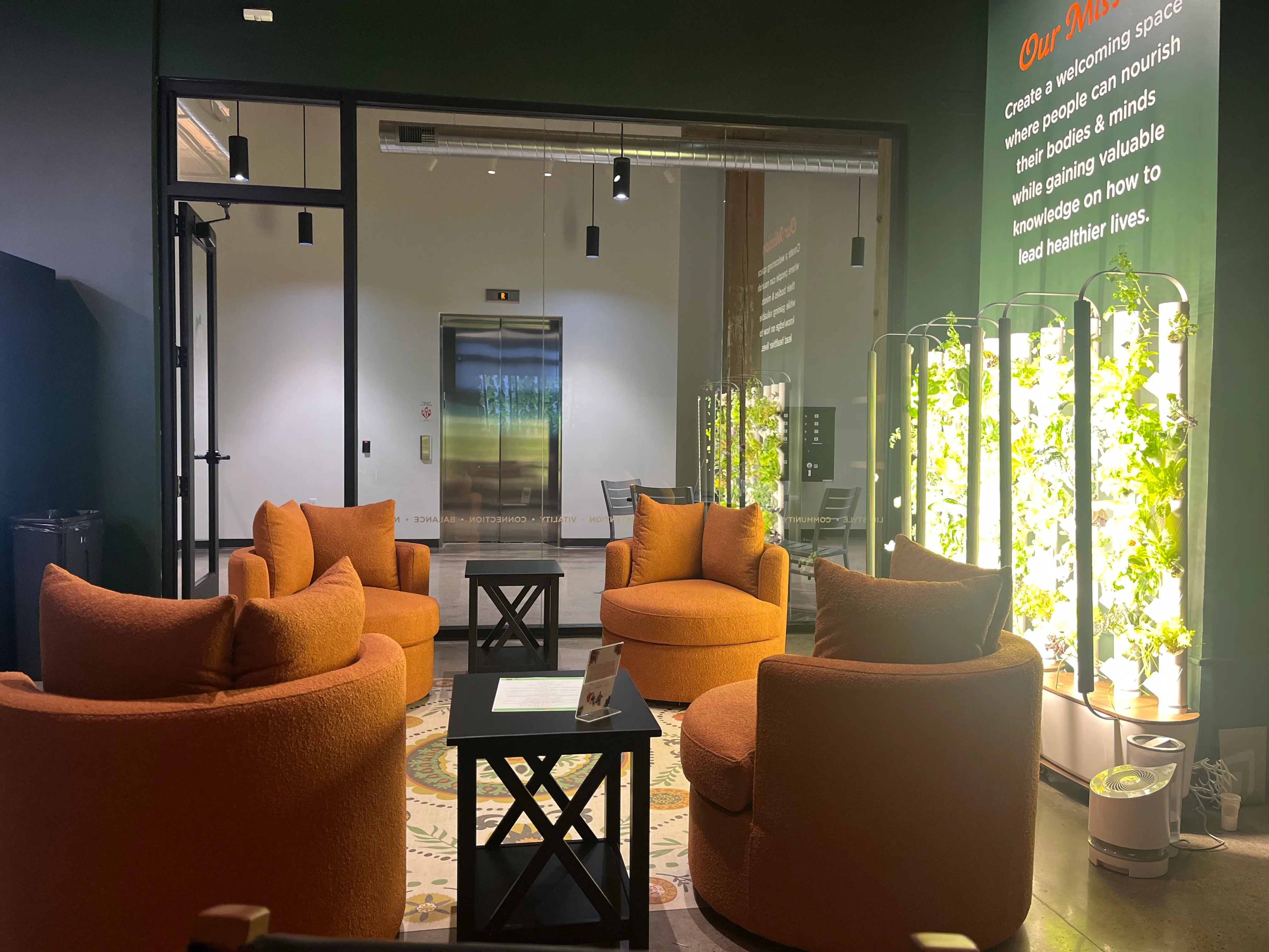 Cozy lounge area with orange chairs and indoor plants