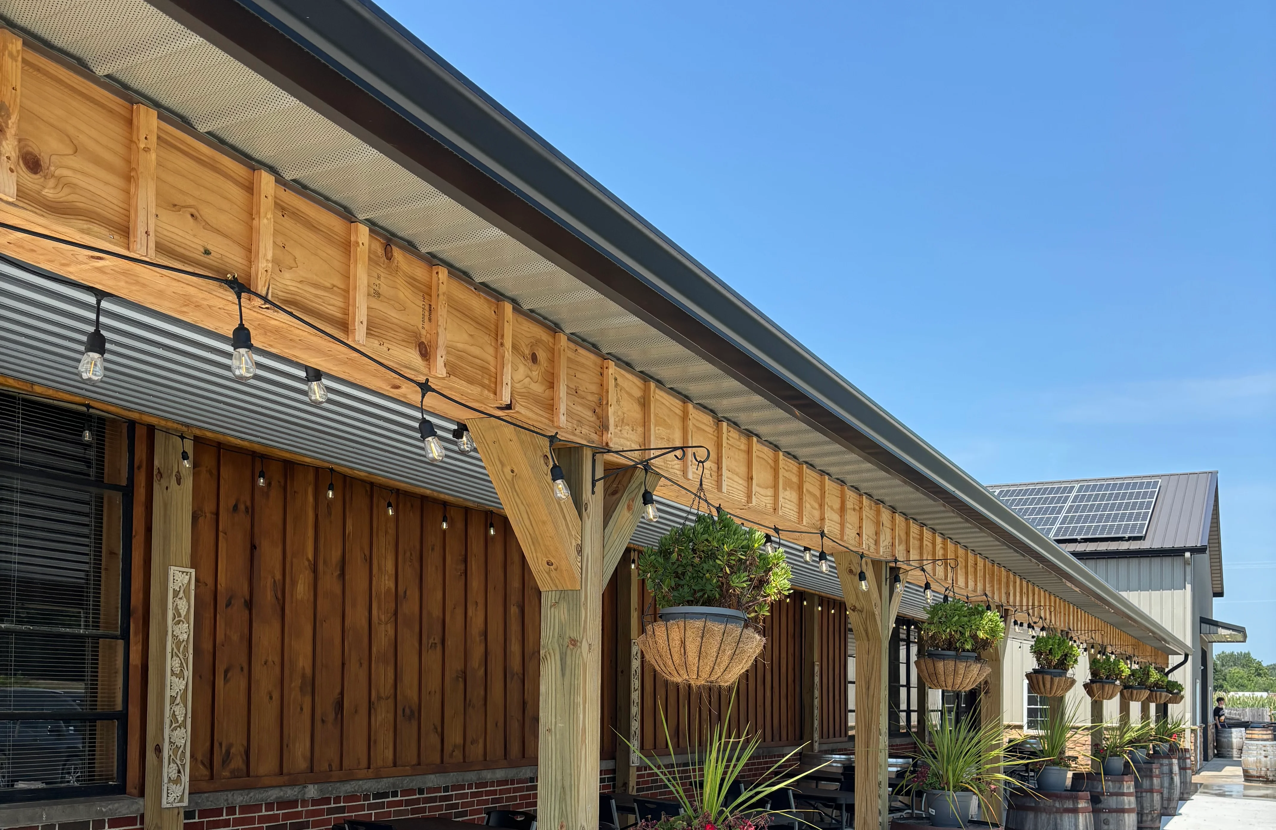 Outdoor dining area with wooden decor and hanging plants