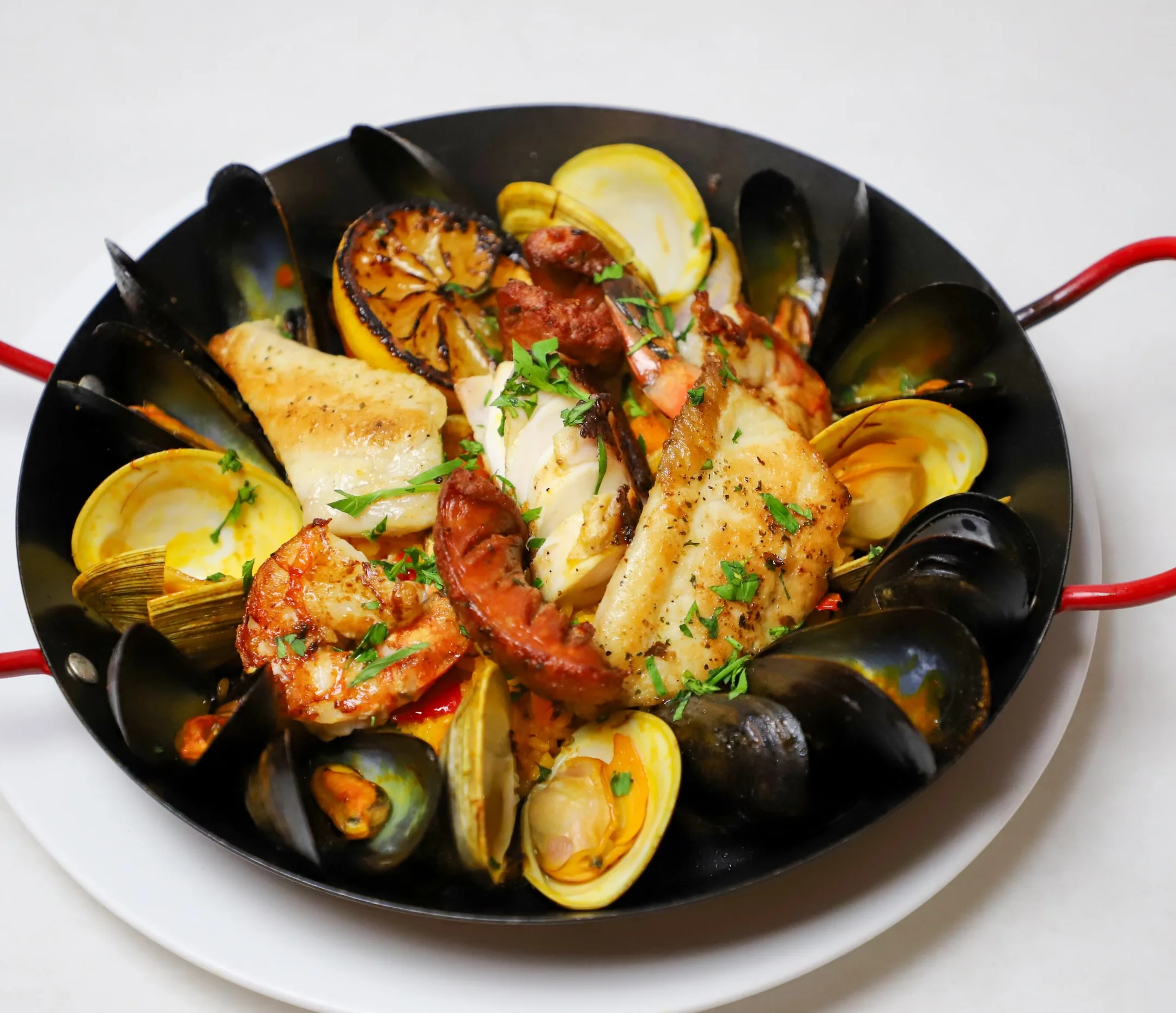 Seafood Paella, served with clams, mussels, shrimp, lobster tail