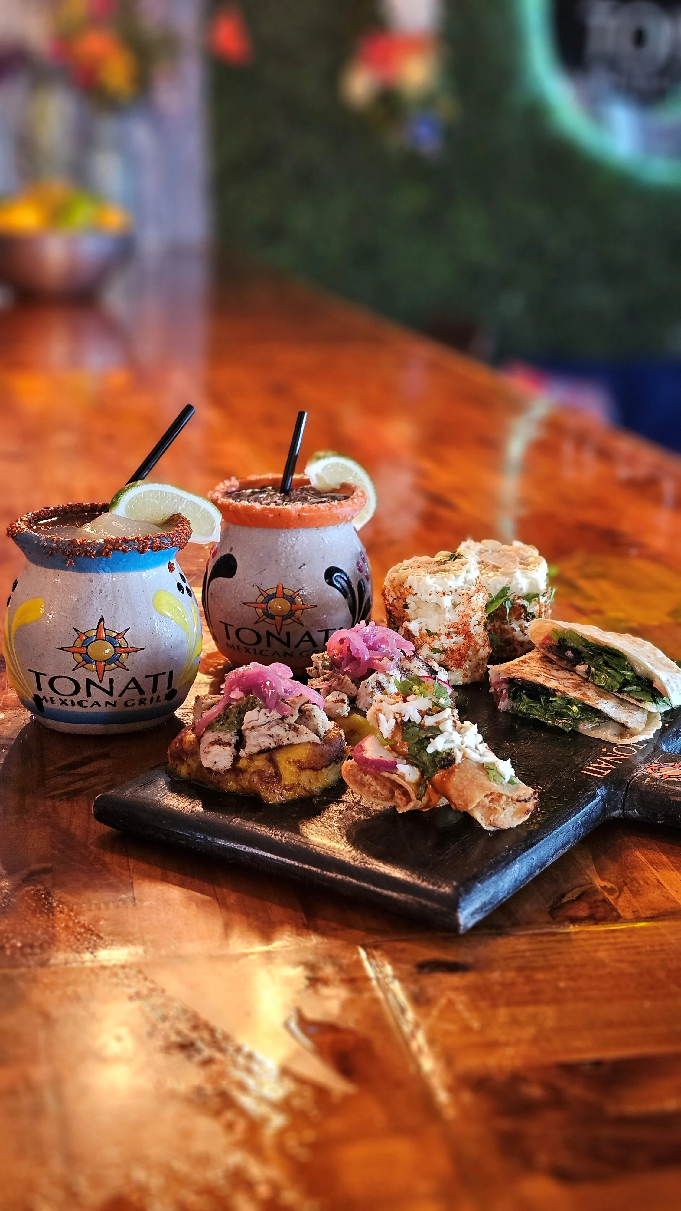Colorful Mexican cocktails and tacos on a wooden table