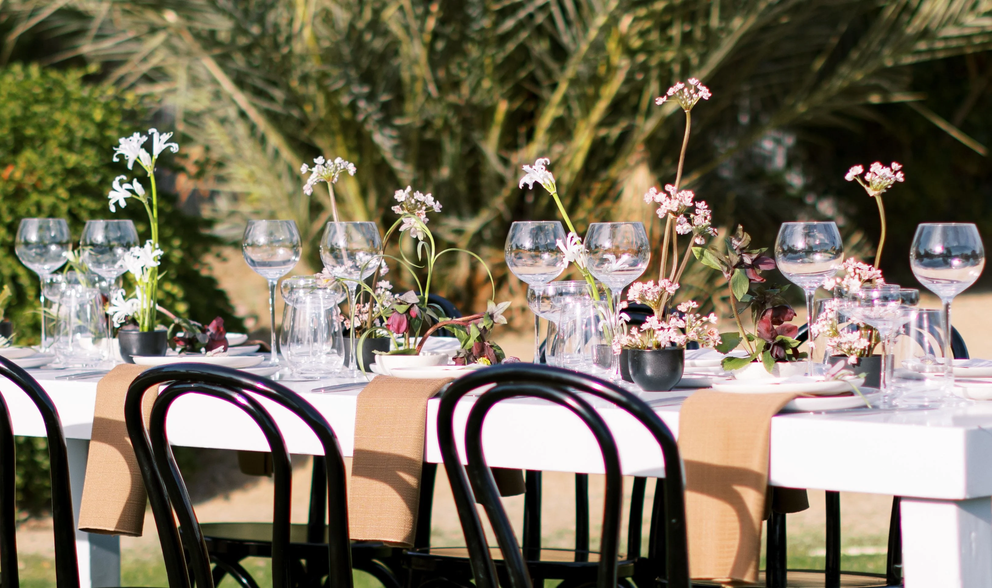 Elegant outdoor dining setup with floral centerpieces