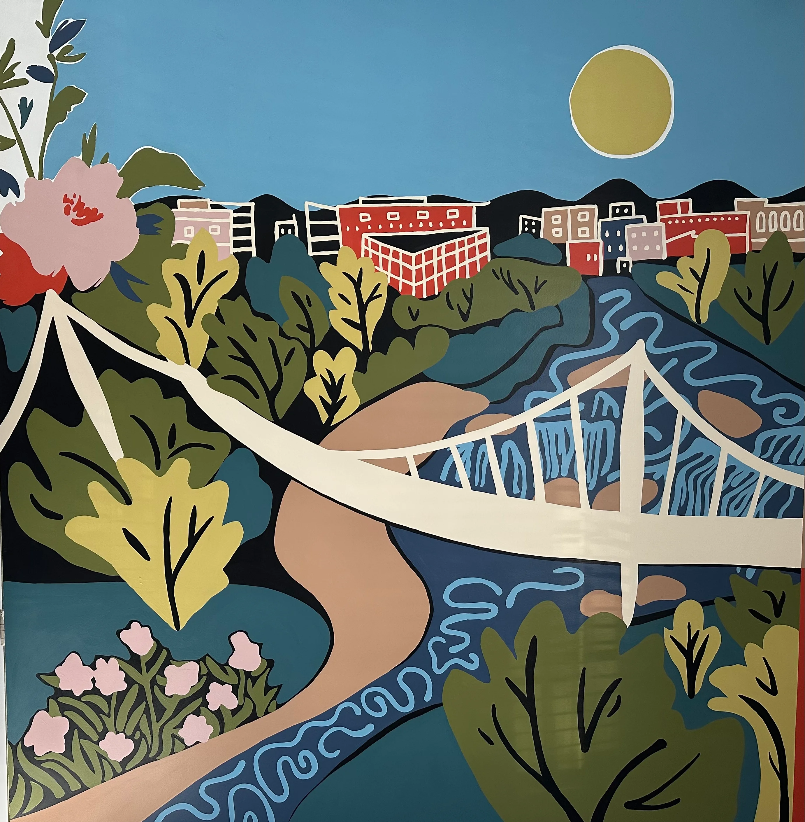 Colorful mural depicting a bridge and landscape with sun and flowers