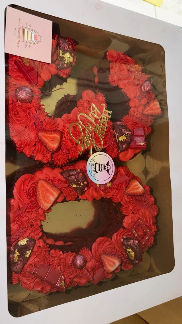 Red velvet birthday cake with strawberries and chocolate decorations