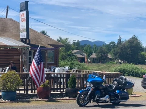 Charming restaurant exterior with American flag and motorcycle