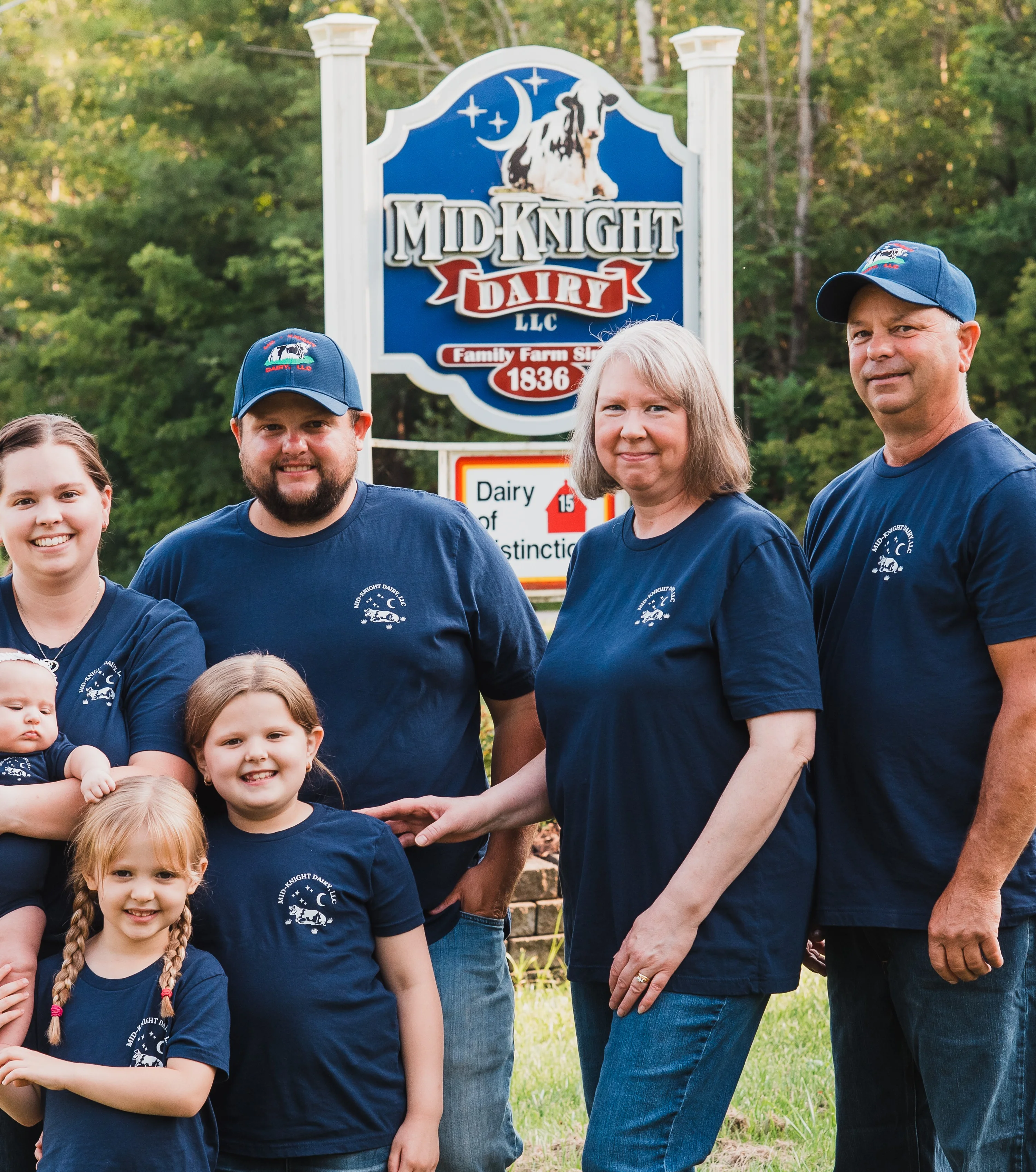 Family portrait in front of Midnight Dairy sign
