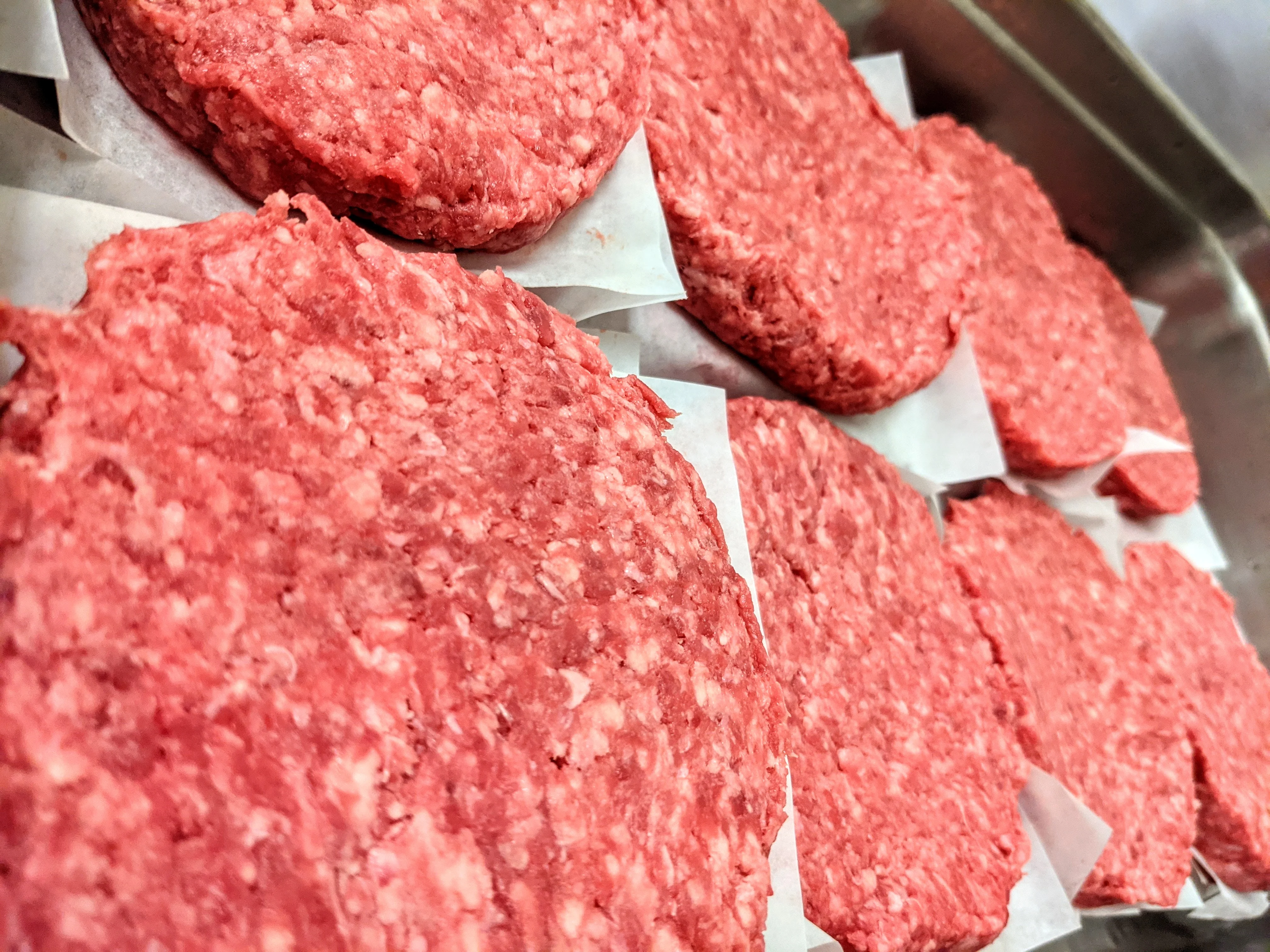 Freshly formed beef burger patties ready for grilling