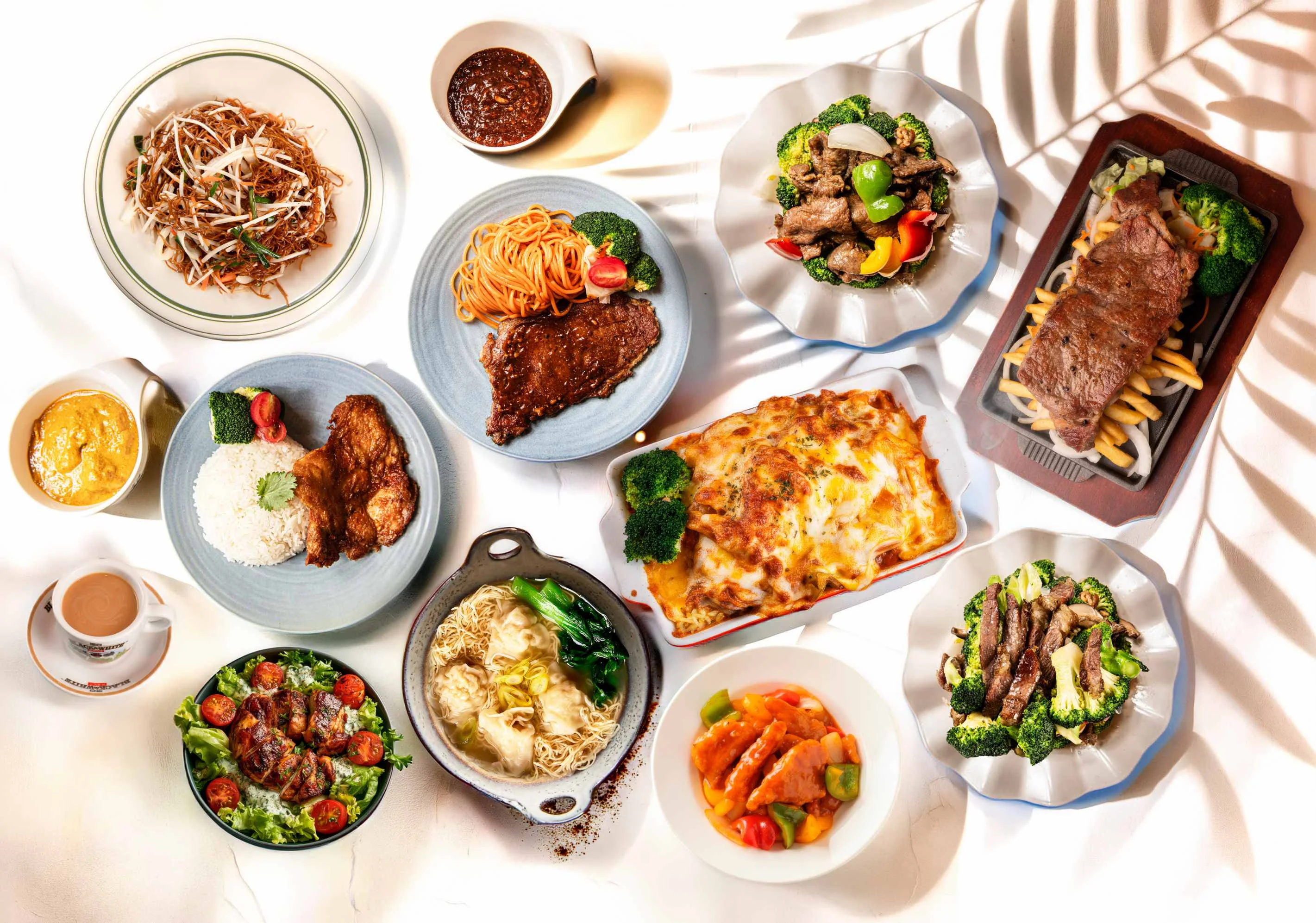 Assorted Asian dishes including stir-fried noodles and grilled meats
