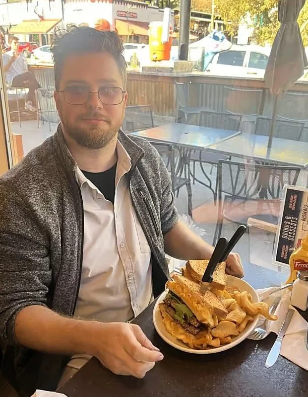 Hearty American cheeseburger with curly fries in a cozy diner