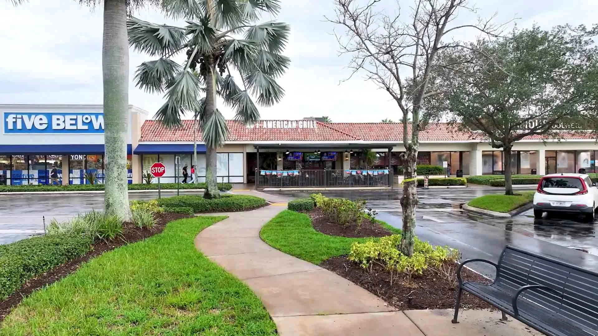 Exterior view of an American grill restaurant with palm trees