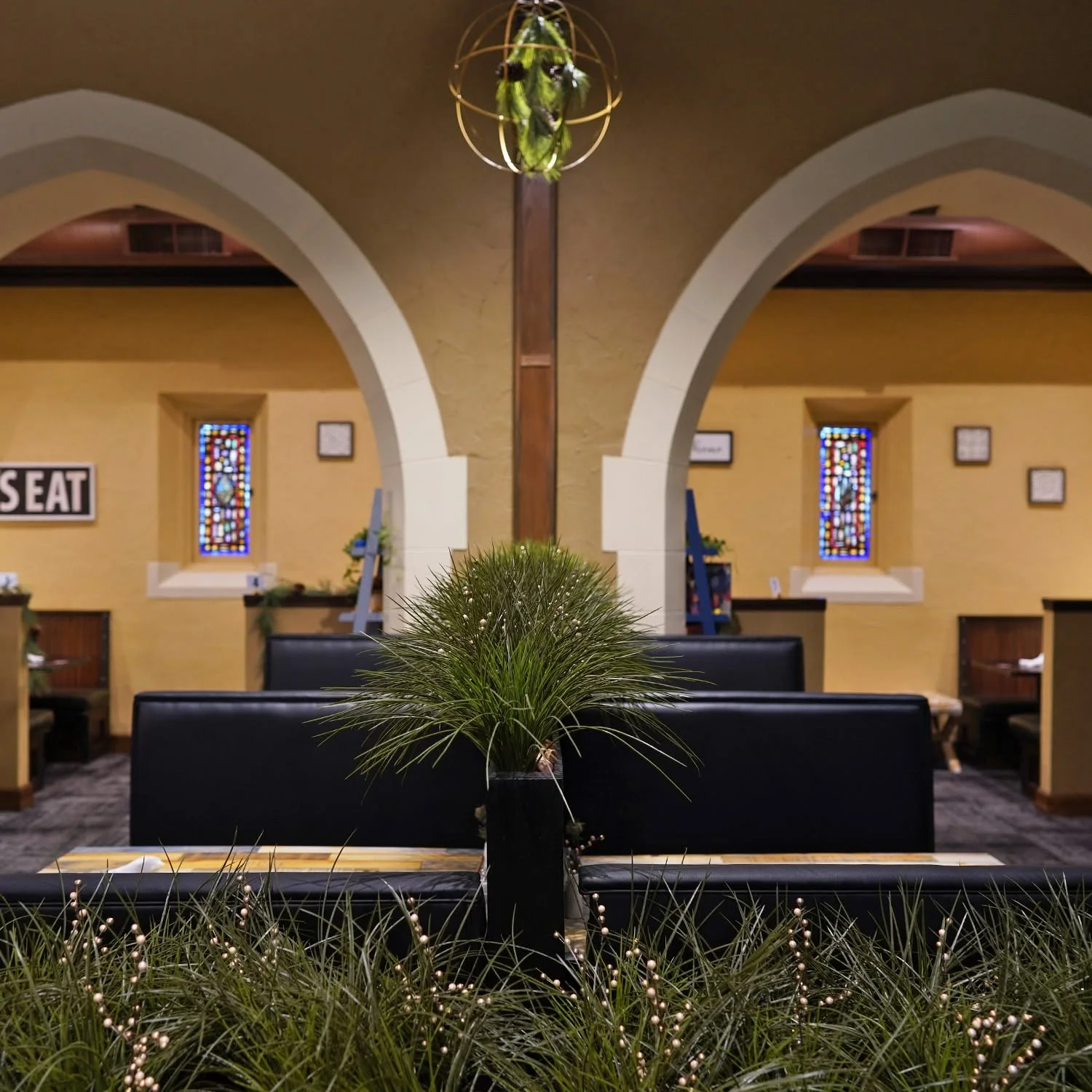 Cozy restaurant interior with arches and decorative plants