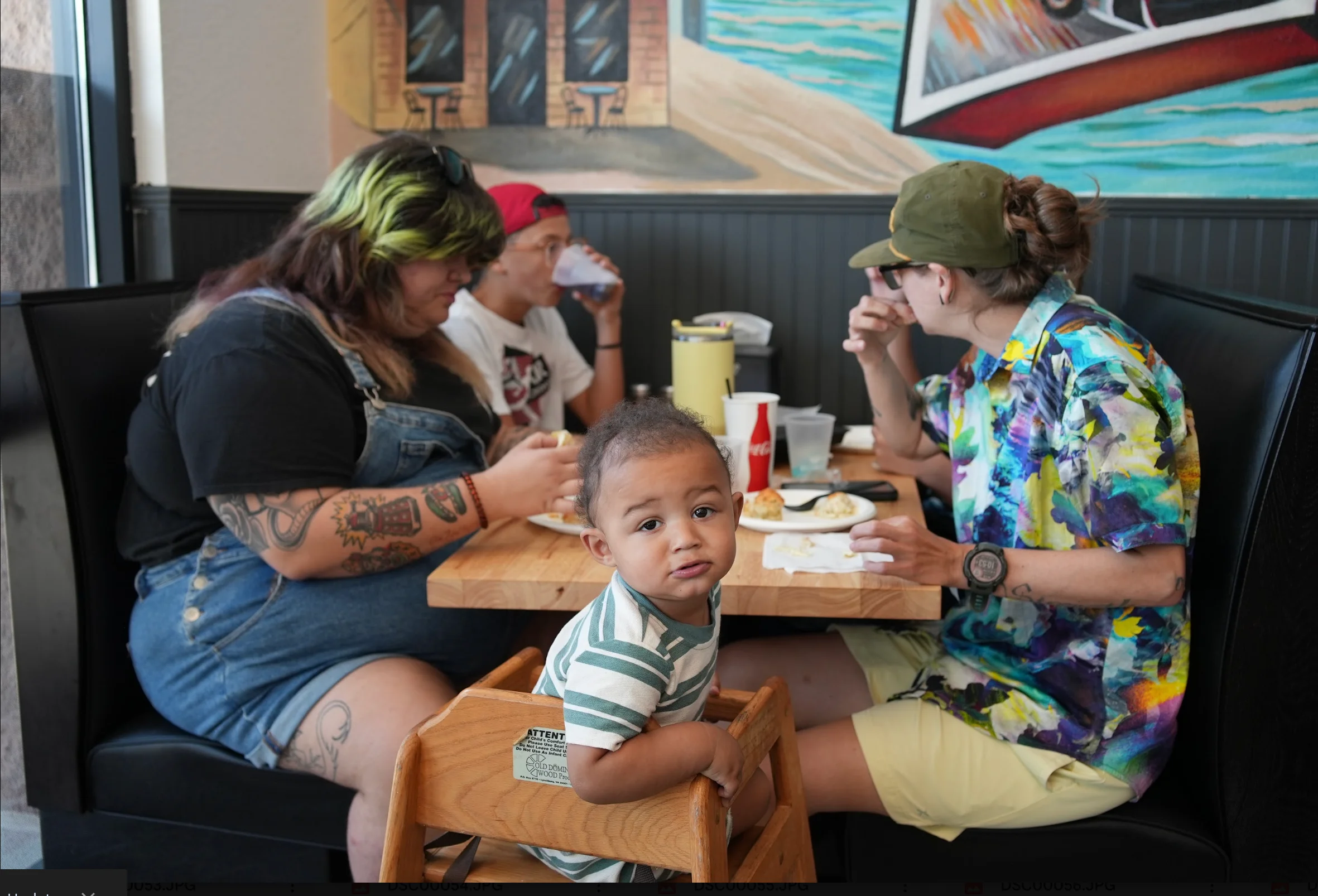 Family dining together in a welcoming restaurant booth