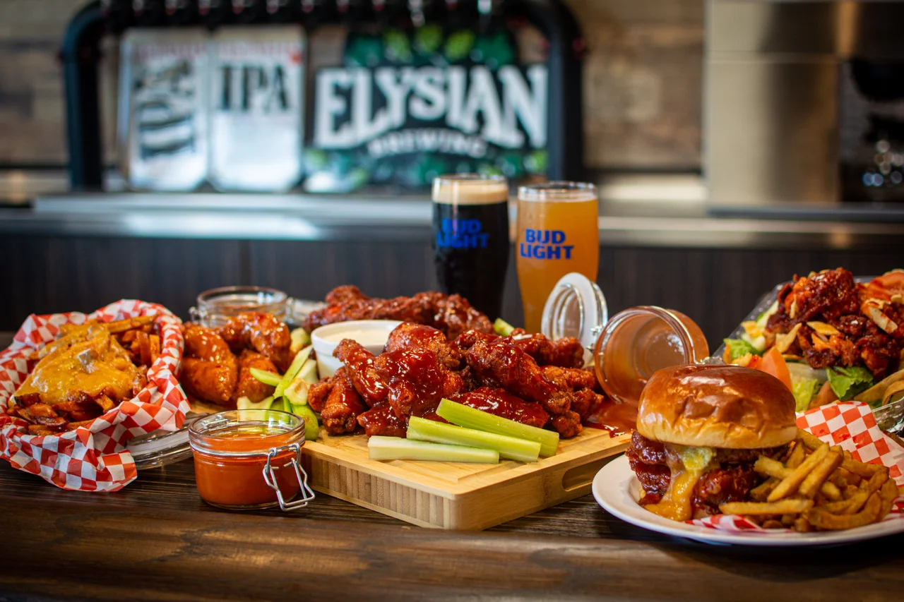 Platter of spicy buffalo wings with celery and dipping sauce