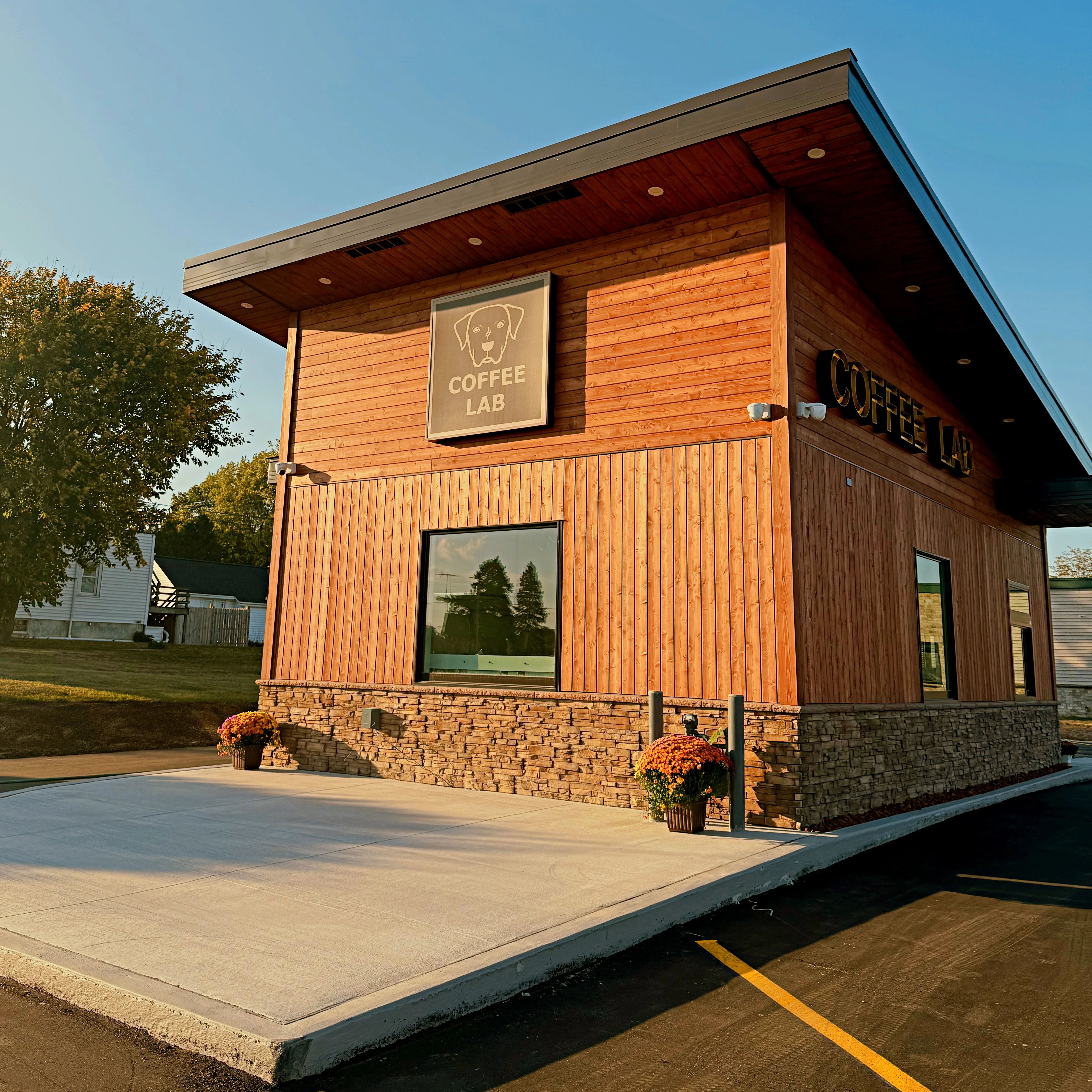 Exterior view of Coffee Lab building with wooden facade and signage.
