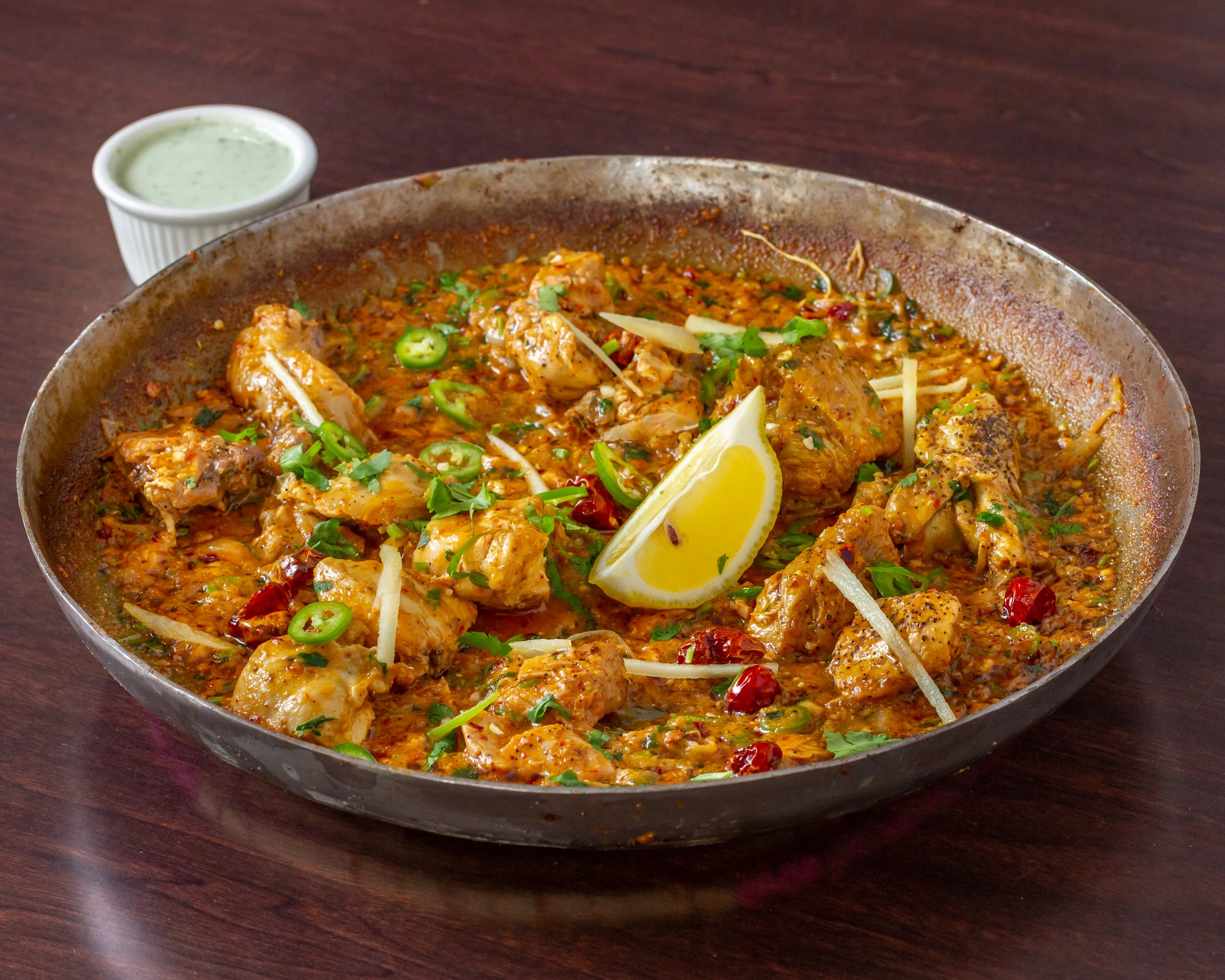 Flavorful Indian butter chicken in a traditional serving pan