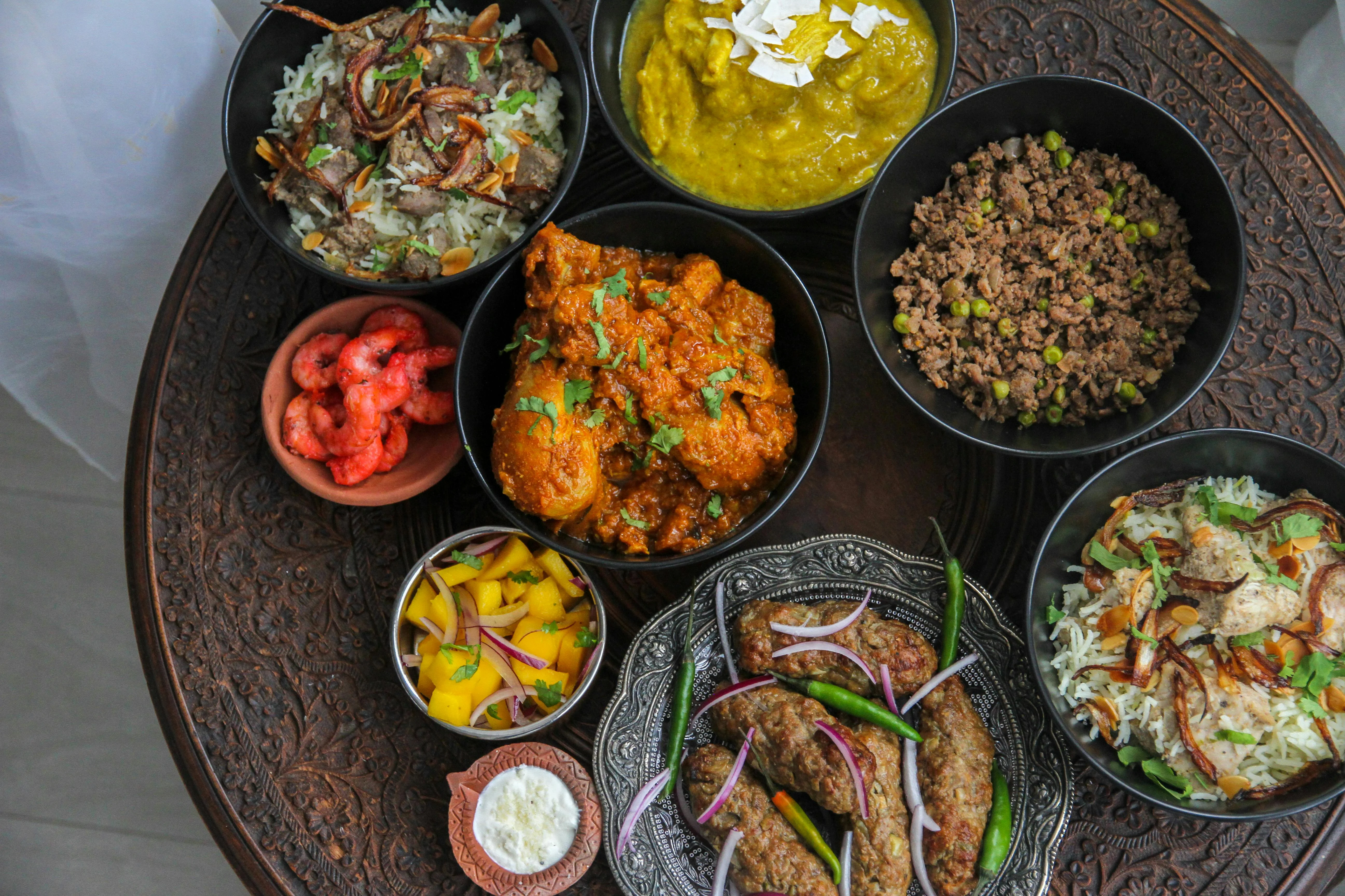 Assorted South Asian dishes including biryani and kebabs