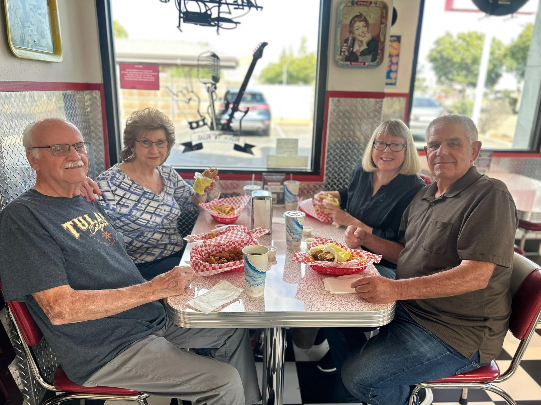 Cozy diner interior with friends enjoying burgers and fries