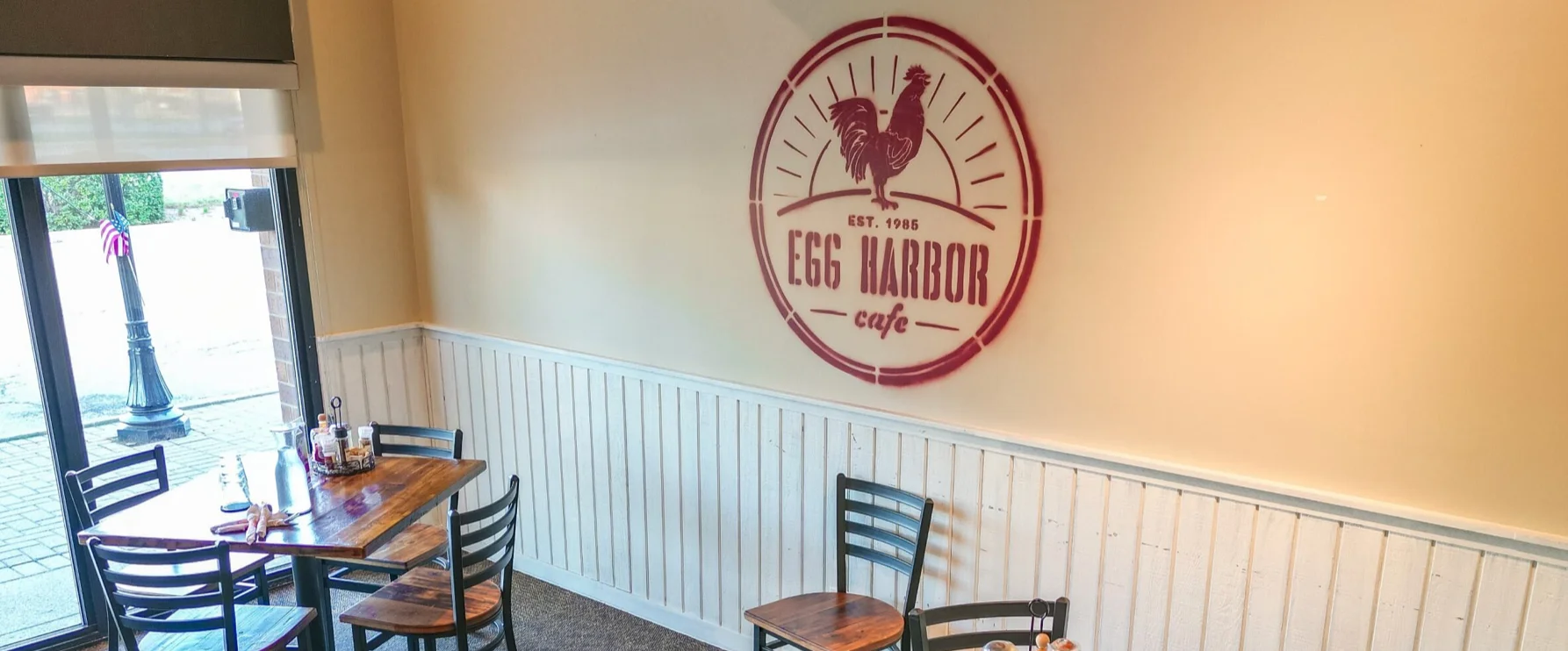 Cozy restaurant interior with Egg Harbor Cafe logo