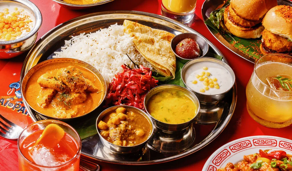 Traditional Indian thali with curry, rice, and sides